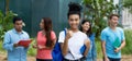 Happy indian female student showing thumb up with group of multi ethnic young adults Royalty Free Stock Photo