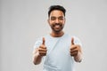 Happy indian man in t-shirt showing thumbs up