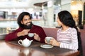 Happy indian man and woman have date at coffee shop Royalty Free Stock Photo