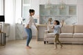 Happy Indian mother with 5s son dancing at home together