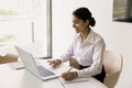 Happy Indian office employee girl using laptop for Internet communication Royalty Free Stock Photo