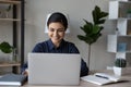 Happy Indian office worker typing on laptop computer at table Royalty Free Stock Photo