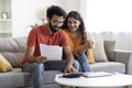 Happy Indian Spouses Checking Financial Documents And Calculating Family Budget At Home Royalty Free Stock Photo