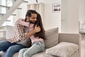 Happy indian teen child daughter embracing dad at home on fathers day.