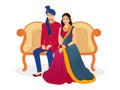 Happy Indian Wedding Couple Character Sit on Sofa in Traditional Royalty Free Stock Photo