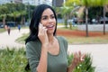 Happy indian woman laughing at phone Royalty Free Stock Photo