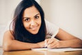 Happy Indian woman student education writing studying