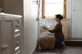 Happy indian woman using modern washing machine for easy laundering