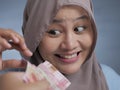 Happy Indonesian Muslim Woman Receiving Rupiah Money