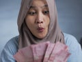 Happy Indonesian Muslim Woman Receiving Rupiah Money