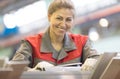 Happy industrial female worker on manufacture workshop background