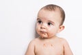 Happy infant baby boy doing a mess eating puree Royalty Free Stock Photo