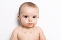 Happy infant baby boy doing a mess eating puree Royalty Free Stock Photo