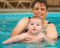 Happy infant baby boy enjoying his first swim Royalty Free Stock Photo