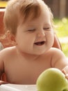Happy infant baby girl spoon eats itself at home. little smiling girl sits in baby-chair and have a breakfast