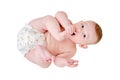 A happy infant baby with teething teeth in a diaper pulls his hand into h Royalty Free Stock Photo