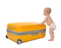 Happy infant baby toddler sitting in yellow plastic travel suitcase Royalty Free Stock Photo