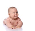 Happy infant child baby girl kid in diaper is lying on her tummy, stomach, crawling, laughing and giggling Royalty Free Stock Photo