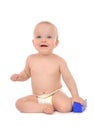 Happy infant child baby girl toddler sitting with blue toy brick