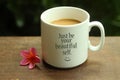 Happy Inspirational quote - Just be your beautiful self.  With white mug of coffee and smiling emoticon self notes on it. Morning Royalty Free Stock Photo