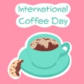 Happy international coffee day. Green cup of coffee with bisquit on pink background