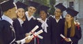 University graduates at graduation talk, congratulate each other and discuss future plans. Royalty Free Stock Photo