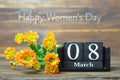 Happy International Womens Day card. Wooden calendar and orange chrysanthemum flowers