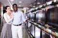 Interracial couple choosing televisor