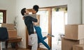 Happy interracial couple hug in new home for property relocation, renovation or investment together. Excited man embrace Royalty Free Stock Photo