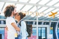 Emotional interracial couple meeting at the airport Royalty Free Stock Photo