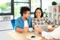 Happy interracial couple with real estate agent in office Royalty Free Stock Photo