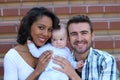 Happy interracial family is celebrating, laughing and having fun with Hispanic African American Mother Royalty Free Stock Photo