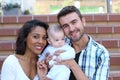 Happy interracial family is celebrating, laughing and having fun with Hispanic African American Mother Royalty Free Stock Photo