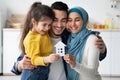 Happy Islamic Family With Little Daughter Holding Cutout Paper House Figure Royalty Free Stock Photo