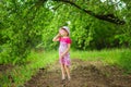 Happy ittle girl in bright dress and funny sunglasses walk in summer garden