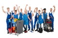 Happy Janitors With Arms Raised Holding Cleaning Equipment Royalty Free Stock Photo