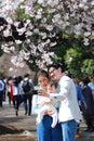 Happy Japanese Family taking Photo under Cherry blossoms