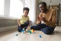 Happy joyful african dad and toddler son laughing playing together Royalty Free Stock Photo