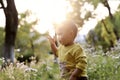 Happy joyful Asia Chinese little boy toddler child enjoy Spring have fun outside embrace nature outdoor carefree childhood flower Royalty Free Stock Photo
