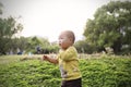 Happy joyful Asia Chinese little boy toddler child enjoy Spring have fun outside embrace nature outdoor carefree childhood meadow Royalty Free Stock Photo