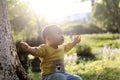 Happy joyful Asia Chinese little boy toddler child enjoy Spring have fun outside embrace nature outdoor carefree childhood meadow Royalty Free Stock Photo