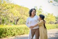 Happy and joyful Asian grandmother and granddaughter showing love, hugging