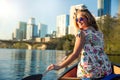 Happy, joyful, cheerful young woman in sunglasses enjoying a hot summer day with water activities, boating, kayaking, and canoeing Royalty Free Stock Photo
