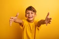 Happy and joyful child wants to hug someone. Yellow background color