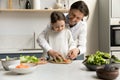 Happy joyful daddy teaching little daughter kid to cook salad Royalty Free Stock Photo