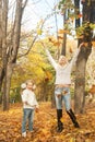 Happy joyful family mother and daughter have a rest outdoor in autumn forest Royalty Free Stock Photo