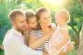 Happy joyful family. Young parents and they little kids having fun