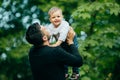 Happy joyful father having fun throws up in the air his small child Royalty Free Stock Photo