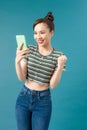 Happy joyful girl holding mobile phone and celebrating a win Royalty Free Stock Photo