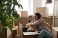 Happy joyful kid sticking out cardboard moving box Royalty Free Stock Photo